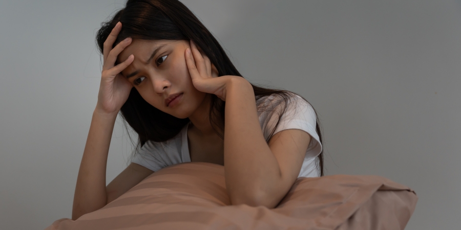 Woman using sleep support patch to ease insomnia and stress